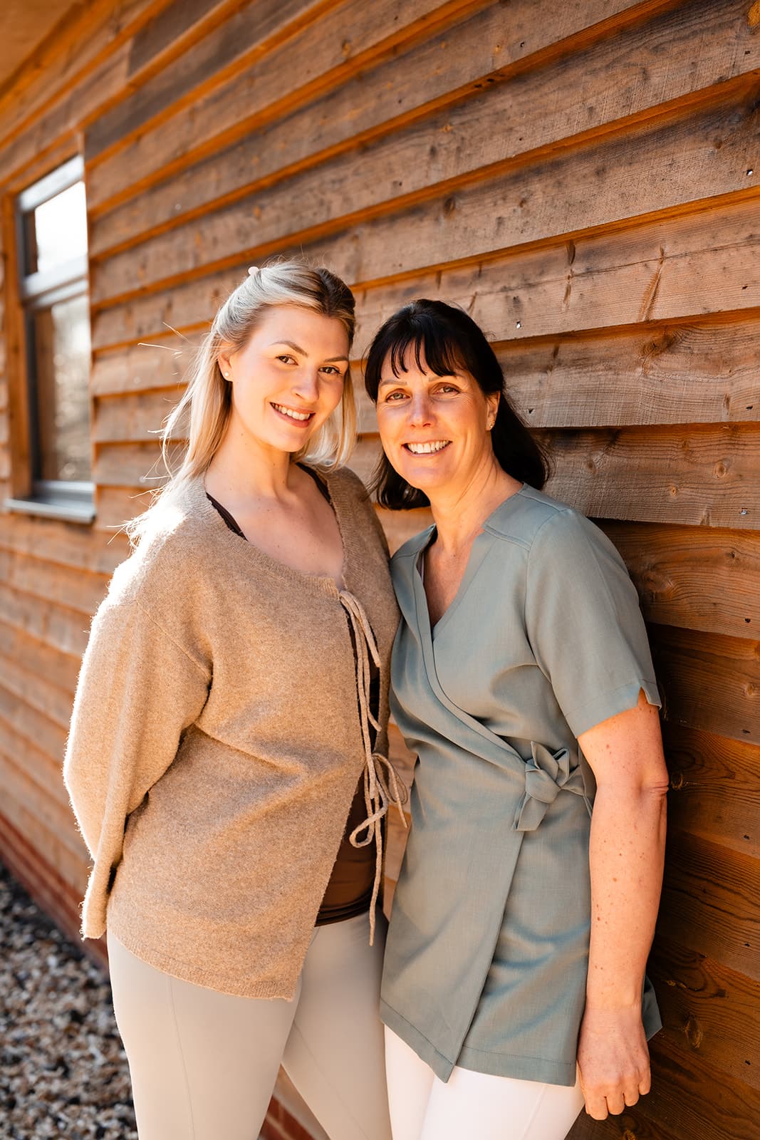 Tiffany and Rosie smiling on a pregnancy ball.