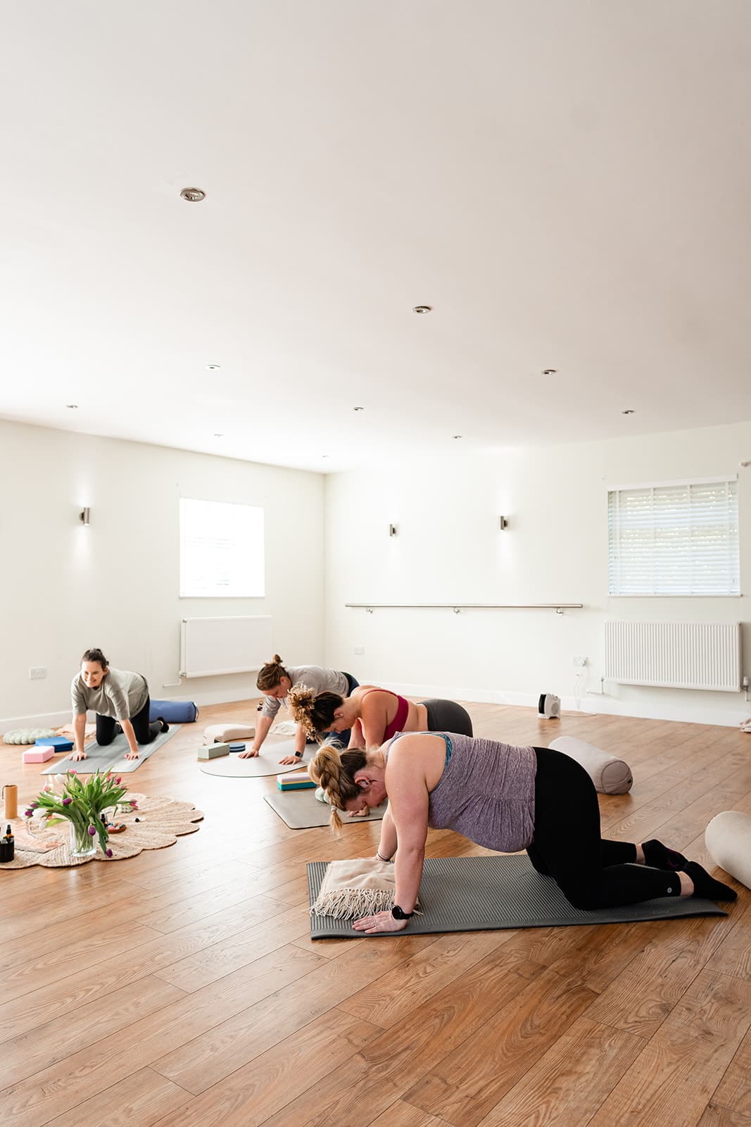 A group of pregnant ladies doing beginner-friendly yoga poses.