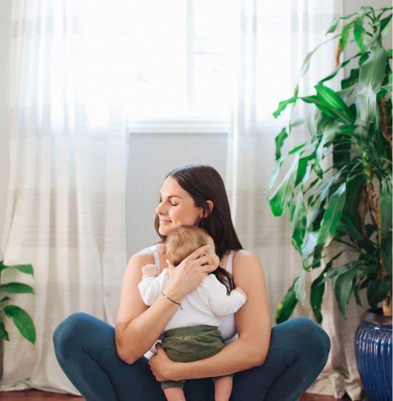 A mother and baby doing yoga.