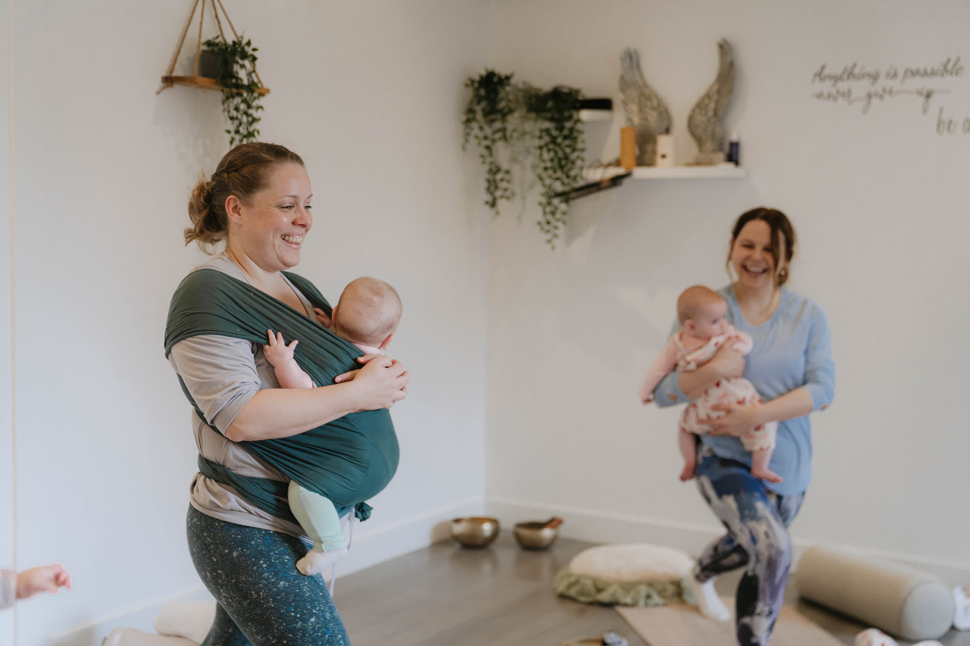 A mother and baby doing yoga.