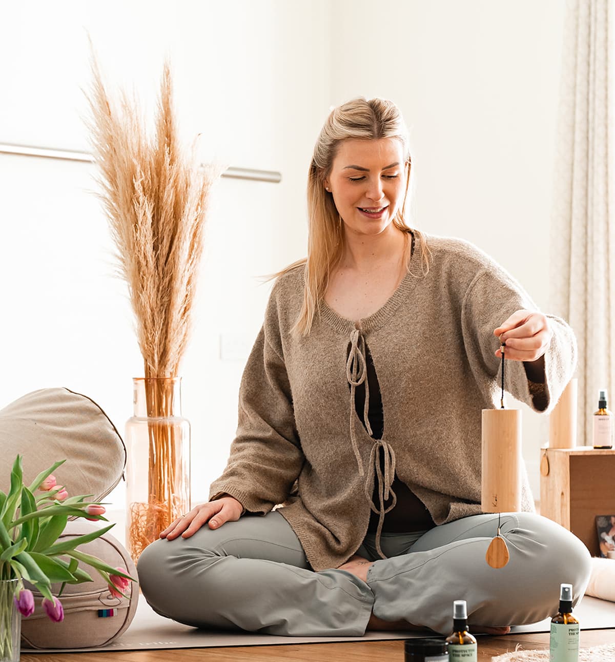 Rose sat on a yoga mat holding a chime.