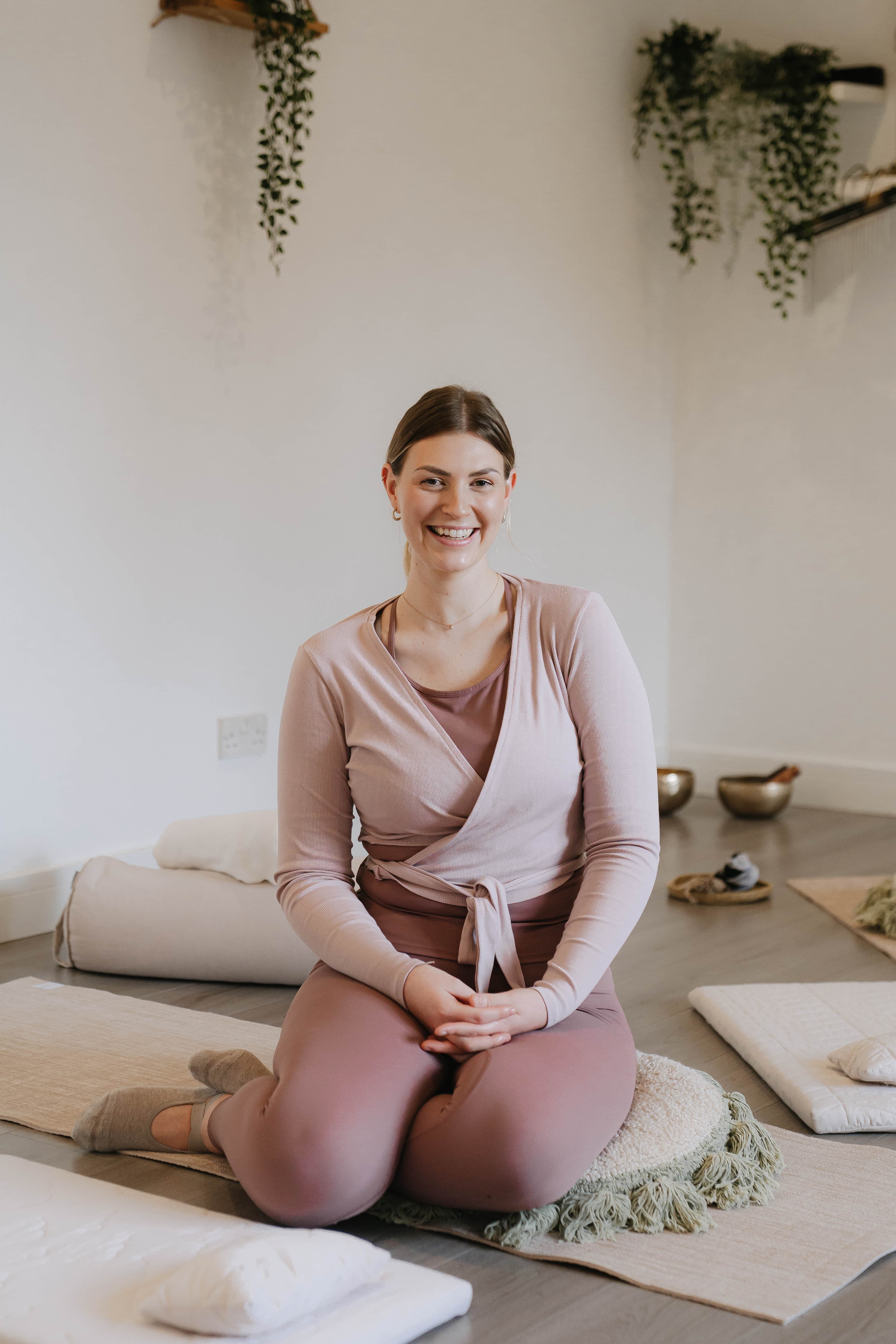 Rosie sat on a yoga pose with candles and cards around her.